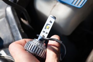 Man,Hand,Installing,H7,Led,Headlight,Bulb,With,Wires.,Modern