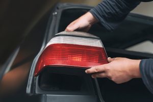 A,Mechanic,Installs,Taillights,In,A,New,Car,At,A
